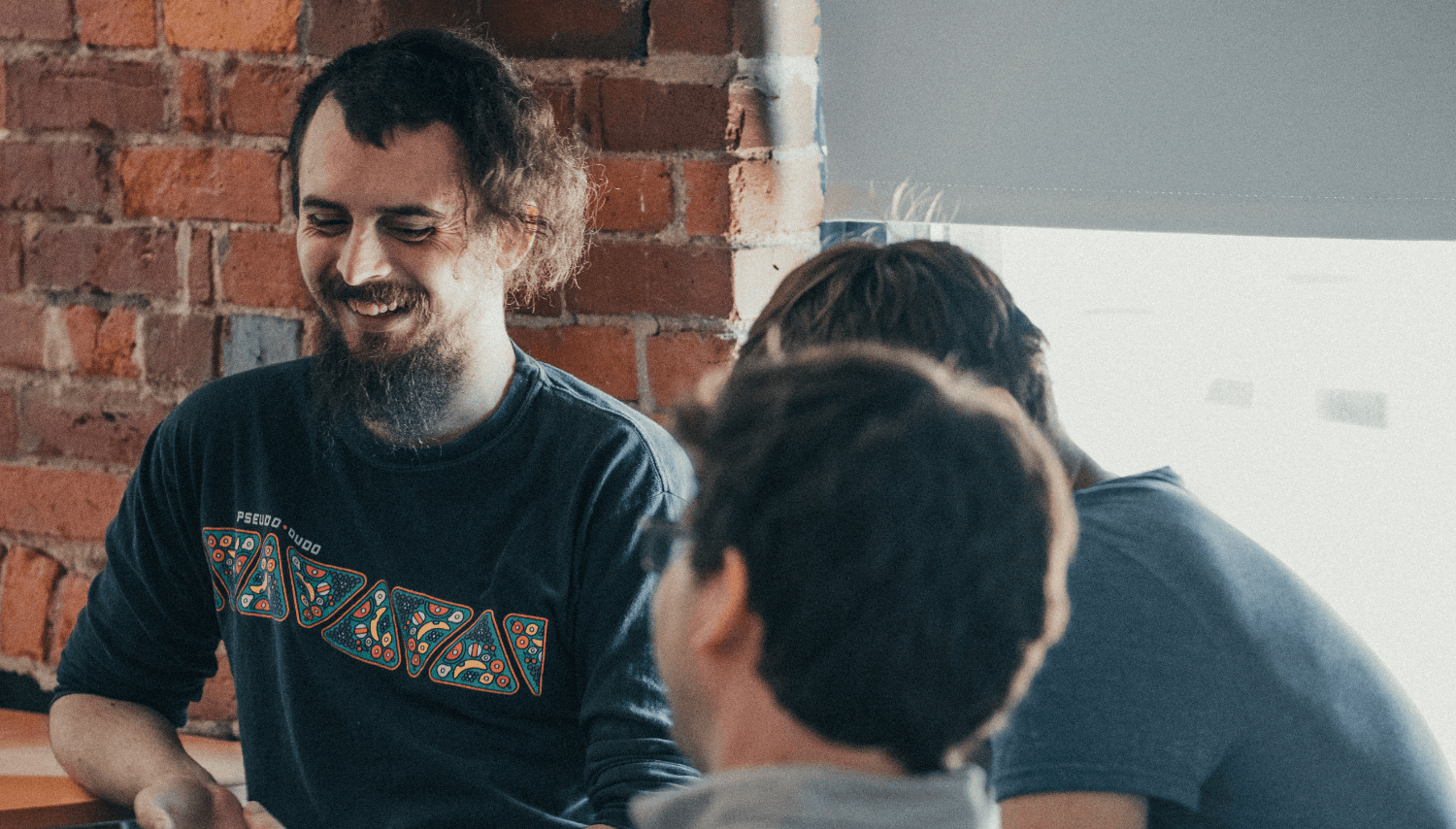 Zach smiling and joking with colleagues